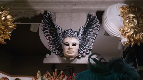 Winged-Venetian-mask-at-Ca'-Macana,-Venice
