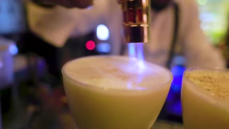 black-male-bartender-is-using-a-blow-torch-to-set-the-drinks-on-fire-in-a-black-owned-bar-in-the-city