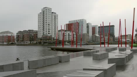 Cloudy-day-view-of-Dublin's-Silicon-Docks-with-modern-buildings-and-red-sculptures,-overcast-sky