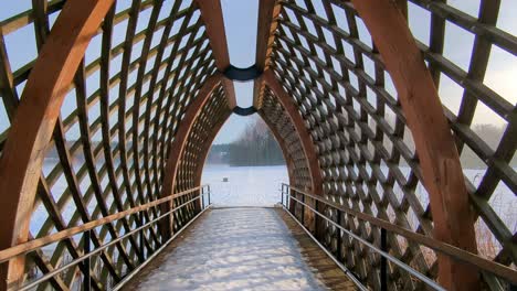 Crossing-dramatic-wooden-bridge,-journey-through-passage,-point-of-view