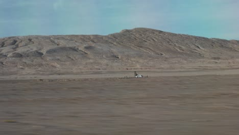 Car-Driving-in-the-Middle-of-the-Desert-Rock-Formation-Side-Seat-POV