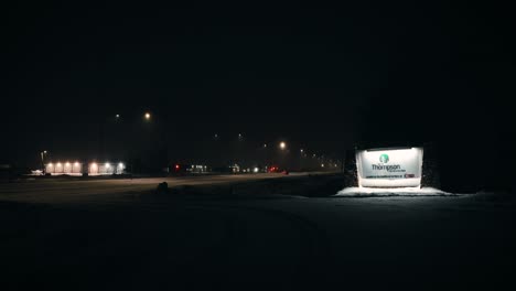 Night-Time-Morning-4K-Shot-Glowing-Car-Traffic-Highway-Entry-Welcome-Sign-City-Town-Northern-Reservation-Community-Treaty-Five-Hub-of-the-North-Nickel-Mine-Thompson-Manitoba-Canada