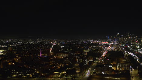 Aerial-view-of-the-skyline-and-the-University-of-Southern-California,-night-in-Los-Angeles,-USA