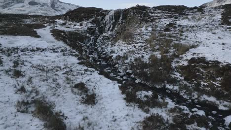 Bride's-veil-waterfall-with-snow-on-the-isle-of-skye,-scotland,-aerial-view