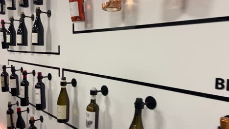 Selection-of-rosé,-white-and-red-wines-displayed-on-the-wall-of-a-Spanish-cellar-gallery