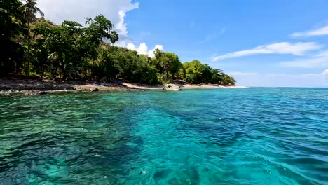 Scenic-ocean-view-of-fishermen-from-local-community-on-fishing-boat-in-stunning-crystal-clear-turquoise-water-of-remote-tropical-island-of-Atauro-in-East-Timor,-Southeast-Asia