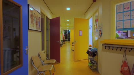 Empty-corridor-of-primary-school-building-with-open-classroom-doors