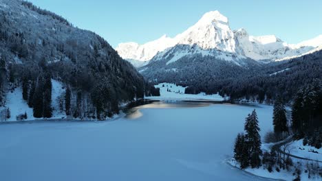 Obersee-Glarus-Switzerland-low-flight-over-lake-at-base-of-amazing-Alps-background