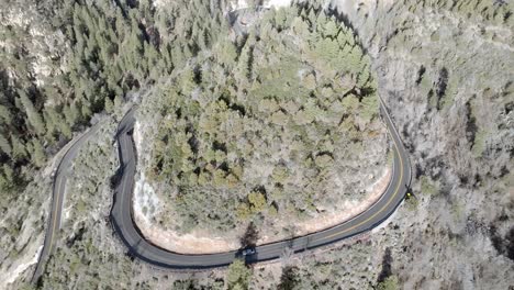 Switchback-road-with-cars-driving-on-Highway-89-A-in-Sedona,-Arizona-with-drone-video-moving-up-medium-shot
