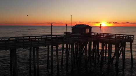 Ocean-fishing-pier-drone-ascend-at-sunrise-at-the-Jersey-Shore