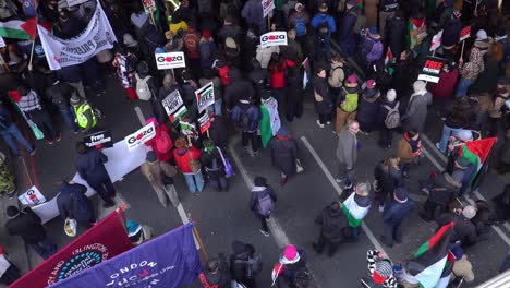 Top-View-of-People-Crowd-Protesting-against-War-in-Gaza,-Pro-Palestine-Street-activists-gather-at-London,-United-Kingdom,-Aerial