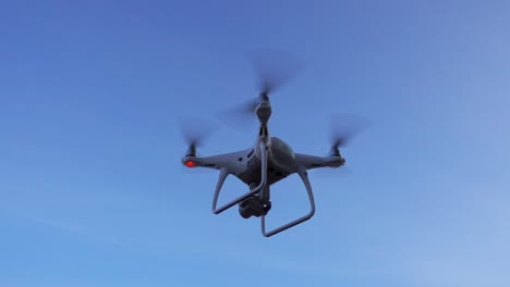 Quadcopter-drone-hovering-and-flying-on-sky-background