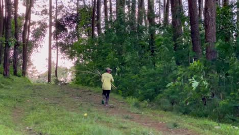 Old-man-searching-dry-wood-branches-to-use-as-cooking-fuel