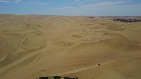 Desert-Buggies-Drive-Across-Atacama-Terrain,-Shot-from-an-Aerial-Drone-Over-the-Vast-Landscape