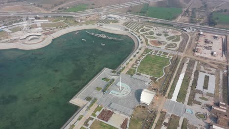 Rajkot-Atal-lake-drone-view-Big-lake-and-many-big-gardens-around-and-big-clock-is-also-visible,-Rajkot-New-Race-Course,-Atal-Sarovar