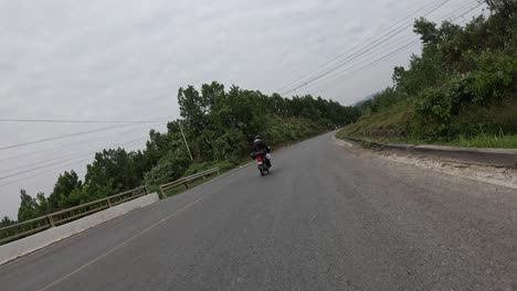 Road-curve-while-driving-with-motorbike,-POV