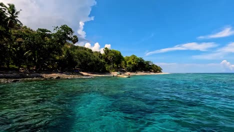 Beautiful-scenic-view-of-remote-tropical-island-with-fishing-boats-and-turquoise-ocean-water-on-the-popular-diving-destination-of-Atauro-Island-in-East-Timor,-Southeast-Asia