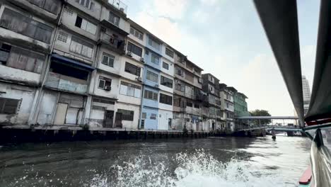 Chao-Phraya-River-with-boat-transport-going-under-bridge,-View-from-boat-shot