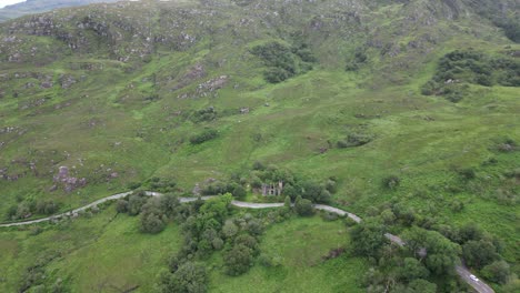 Ladies-view-in-ireland-showcasing-verdant-landscapes-and-a-historical-structure,-daytime,-aerial-view
