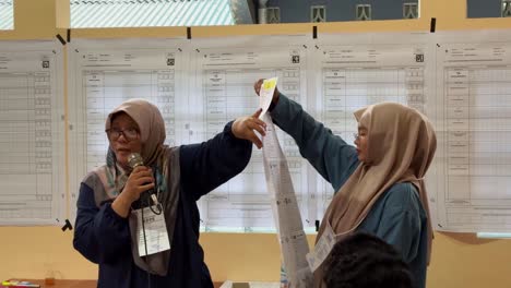 Workers-telling-instruction-for-president-election-in-Indonesia