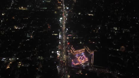 Rajkot-aerial-drone-view-is-going-towards-without-drone-camera-where-lots-of-vehicles-are-going-over-the-bridge-and-lots-of-buildings-and-big-complexes-are-visible-around