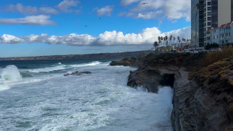 King-tide-at-La-Jolla-Cove-view-over-large-seascape-with-ocean-waves-smashing-and-crashing-on-clliffs