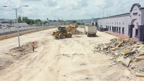 Debris-collection-after-demolition-with-a-bulldozer-and-a-loading-truck