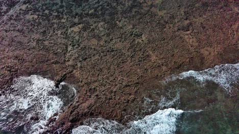 Sea-foam-and-relief-on-sand-at-Corralejos-beach,-Fuerteventura