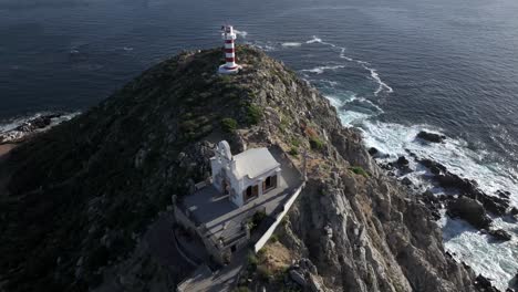 Church-on-top-of-mountain-top-next-to-El-Encanto-Lighthouse-overlooking-the-Sea-of-Cortez,-Cabo,-Mexico