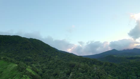 Endless-tropical-jungle-on-slopes-of-mountain-range-in-Guadeloupe,-aerial-view