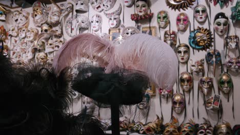 Feathered-Venetian-masks-display,-Ca'-Macana-Venice