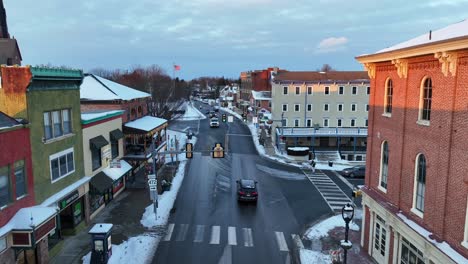 Rising-drone-shot-of-cars-on-wet-road-during-sunset-time-in-winter