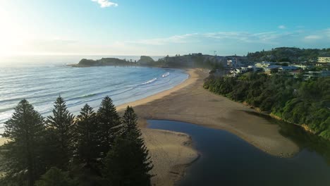 Drone-aerial-Terrigal-beach-bend-lagoon-foreshore-ocean-waves-pine-trees-channel-inlet-rural-suburban-town-morning-sunrise-Central-Coast-Australia