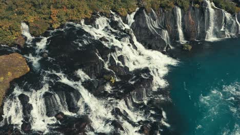 Incredibly-gorgeous-drone-aerial-of-green-pools-and-waterfalls-against-a-river-landscape-in-Gullfoss-Iceland