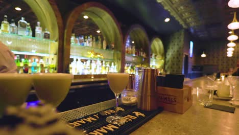 black-male-bartender-is-pouring-a-crafted-cocktail-in-a-glass-to-serve-to-customer-a-local-bar