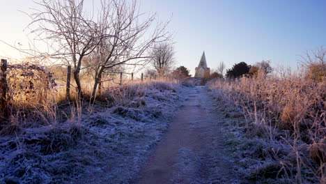 Wide-shot-of-winter-heavy-frost-on-pathway-leading-to-Farley-Mount-monument-UK-4K