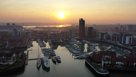 Aerial-orbiting-over-boat-harbour-Ocean-Village-Southampton-during-sunset-4K