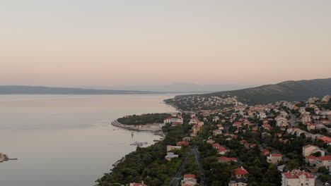 Vacation-homes-by-the-sea-in-Novi-Vinodolski,-Adriatic-coastline,-Croatia,-sunrise,-quiet-morning-by-the-sea,-mountains,-houses,-vacation-rentals,-tourism,-popular-holiday-destinations,-balkan-summer