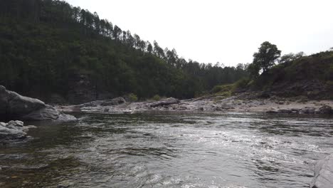 Silver-River-Water-Flow-Landscape-around-Dark-Green-Sierras-in-Indigenous-Land,-Calamuchita-Valley-in-Córdoba-Argentina