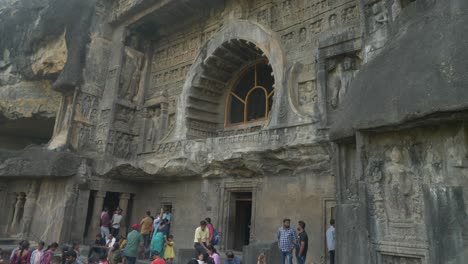 Tourists-at-Ajanta-Cave-26-entrance,-The-sculptures-at-Cave-26-entrance-of-Ajanta-Caves