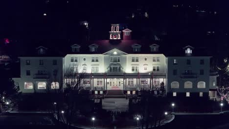 Aerial-ascend-perfect-frontal-establishing-of-old-hotel-at-night