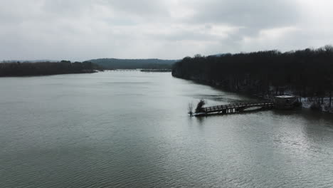 Scenic-aerial-drone-view-of-vast-lake-Sequoyah-in-Arkansas,-old-bridge,-cloudy