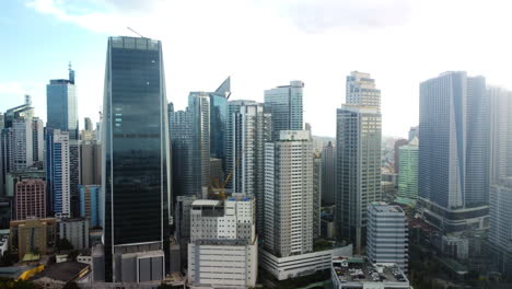 Aerial-view-of-modern-skyscrapers-of-Makati-skyline,-in-sunny-Manila,-Philippines