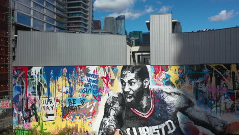 Aerial-view-in-front-of-the-Kobe-Bryant-murals-and-Graffiti-towers-in-Downtown-Los-Angeles