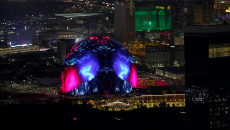 Illuminated-MSG-Sphere-With-Abstract-Artistic-Graphics-Being-Shown-At-Night-In-Las-Vegas