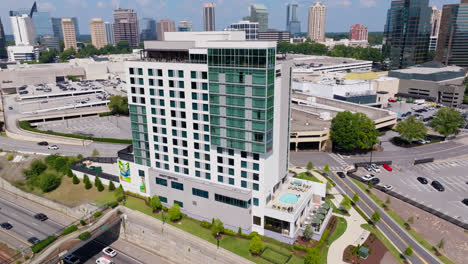 Traffic-on-highway-beside-Hyatt-Centric-Buckhead-Atlanta-Hotel-at-sunny-day