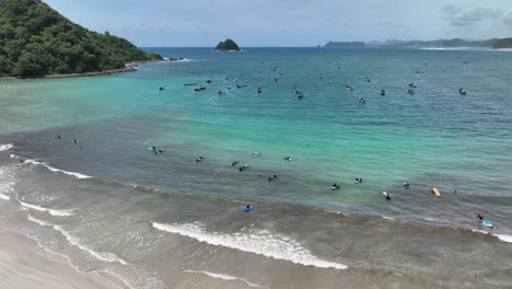 Surfers-at-Kuta-Beach-on-the-island-of-Lombok,-Indonesia