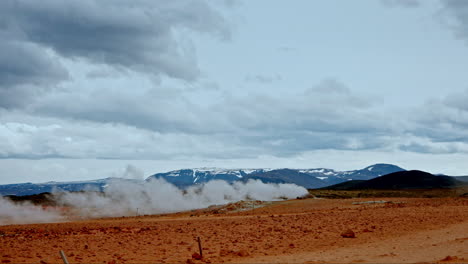 Wide-shot-of-a-column-of-fumarole-near-mount-Námafjall-in-Hverir-geothermal-area,-Iceland