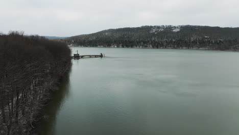 Aerial-view-of-vast-Lake-Sequoyah-tranquil-water-on-a-winter-day,-old-bridge
