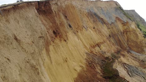 Aerial-Flying-Close-Along-Large-Coastal-Cliff-Fall-at-Seatown-Beach